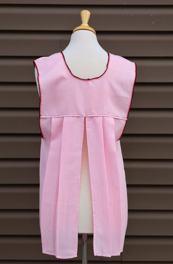 Back view of baby pink gingham Mexican apron showing the open-back design
