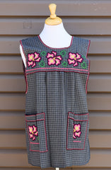 Gray plaid Mexican apron with colorful cross-stitch embroidery and front pockets