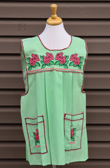 Light green gingham Mexican apron with colorful cross-stitch embroidery and front pockets