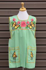 Light green gingham Mexican apron with colorful cross-stitch embroidery and front pockets