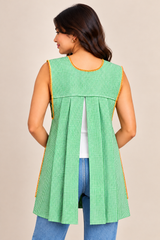 Back view of a handmade Mexican lime green gingham apron featuring an open-back design, pleated fabric panels, and decorative trim.