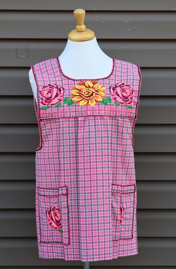 Pink plaid Mexican apron with colorful cross-stitch embroidery and front pockets