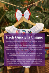 A white baby bodysuit with colorful floral embroidery, hanging on a wooden hanger with a matching white bow headband. The background features lush green houseplant leaves, and a large purple text box overlays the lower half with information about customization.